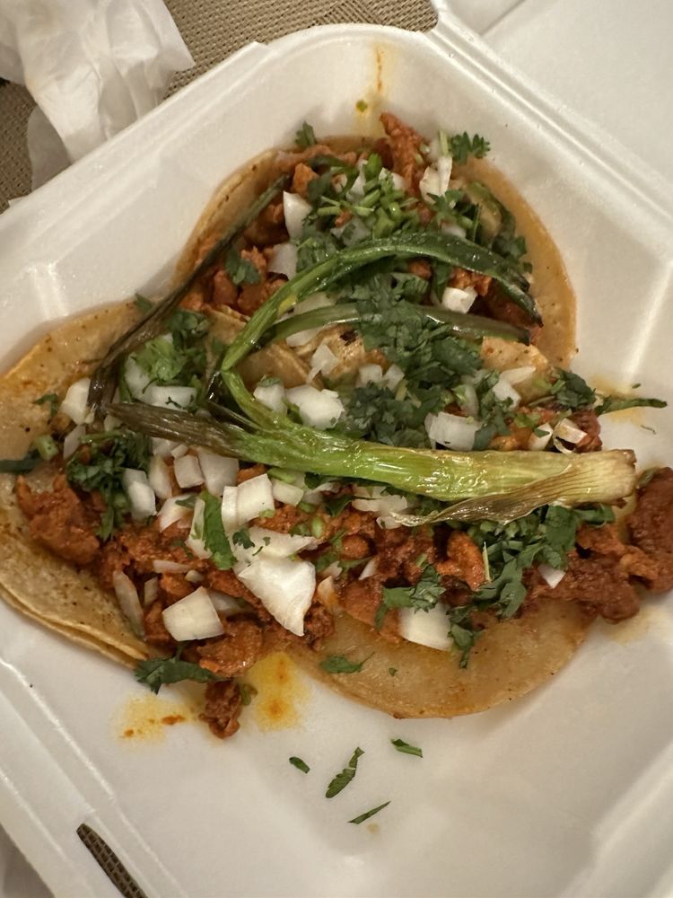Adobada Taco with marinated pork, onions, and cilantro at La Lomita Mexican Grill. Feel free to modify any details as needed!
