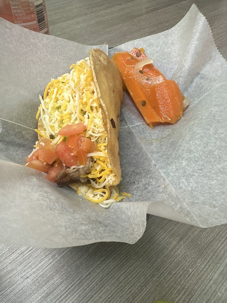 Beef Taco with seasoned ground beef, lettuce, and tomatoes at La Lomita Mexican Grill. Feel free to adjust any details as needed!