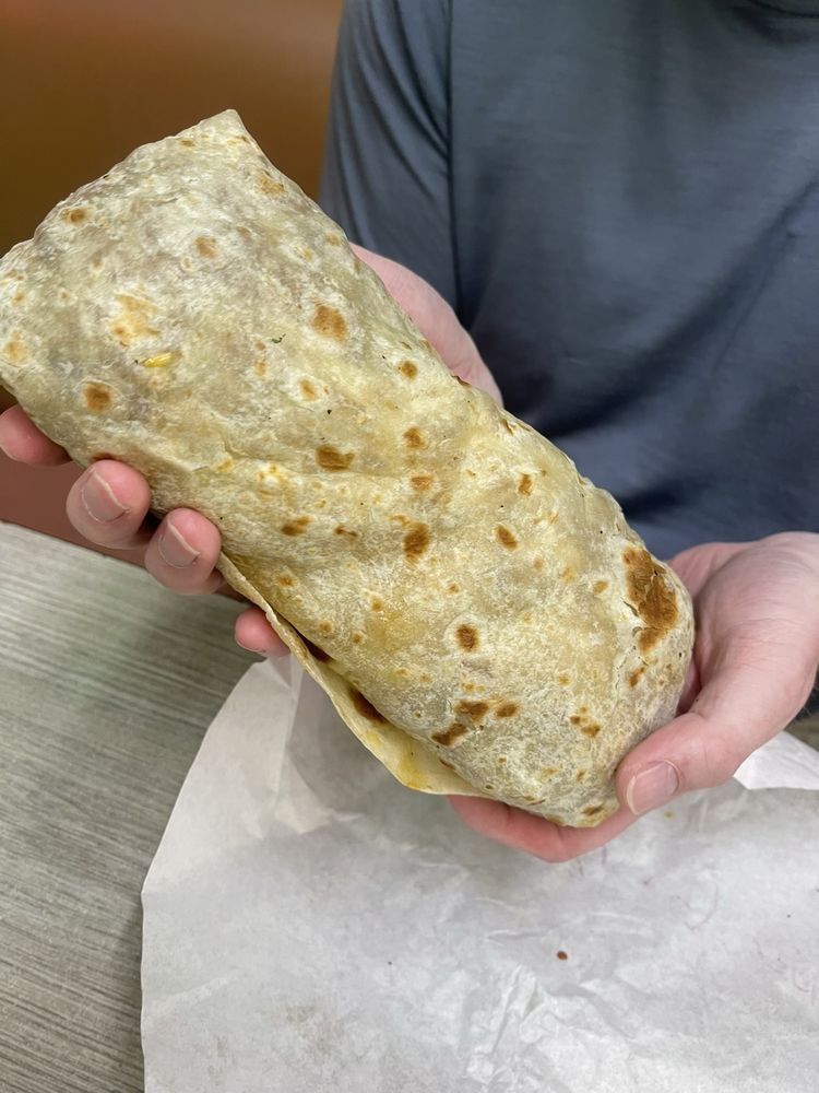 Carne Asada Burrito with grilled steak, rice, and avocado sauce at La Lomita Mexican Grill. Feel free to modify any details as needed!