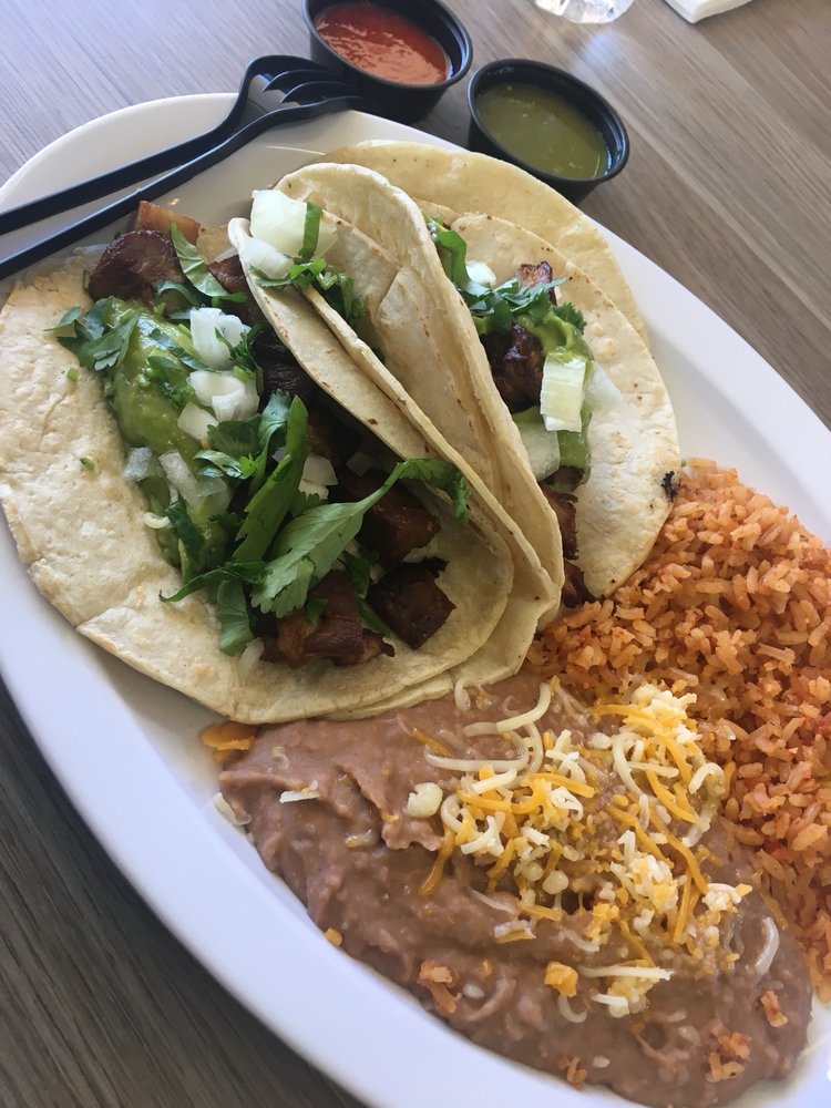 Carnitas Taco with slow-cooked pork, cilantro, and onions at La Lomita Mexican Grill. Feel free to adjust any details as needed!