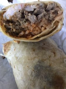 Cielo Mar Y Tierra Burrito with shrimp, carne asada, rice, and beans at La Lomita Mexican Grill. Feel free to adjust any details as needed!