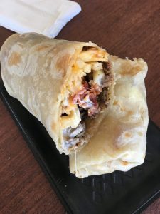 Harbison Burrito with shredded beef, beans, rice, and guacamole at La Lomita Mexican Grill. Feel free to modify any details as needed!