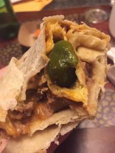 Lomita Burrito with shredded pork, rice, beans, and avocado sauce at La Lomita Mexican Grill. Feel free to modify any details as needed!