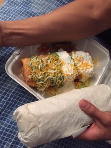 Surf & Turf Burrito with steak, shrimp, rice, and spicy sauce at La Lomita Mexican Grill. Feel free to adjust any details as needed!